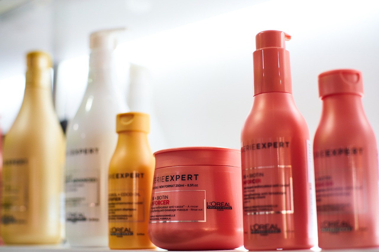 7 bottles of hair product all showing consistent branding on their labels, including bottle styles and colours.