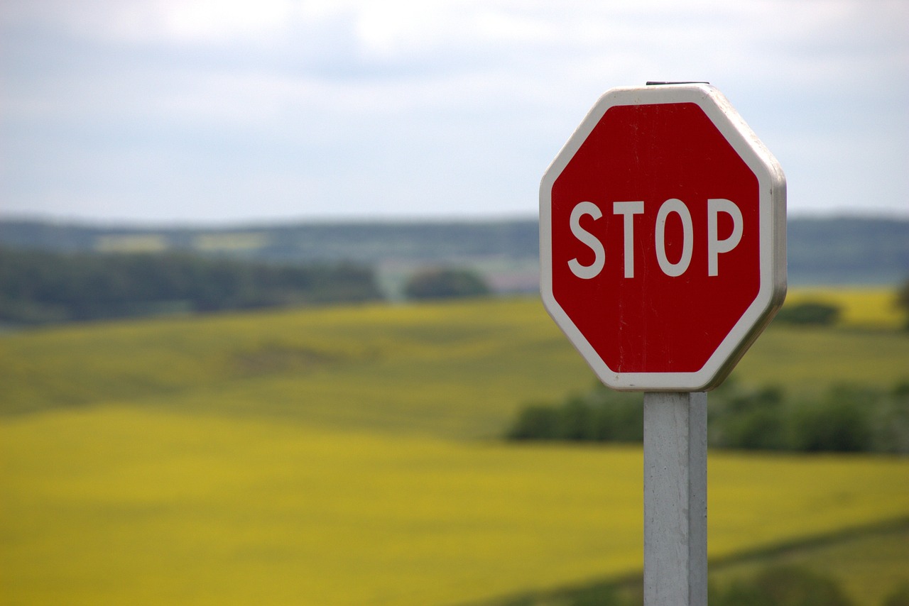 Red stop sign in the middle of a field