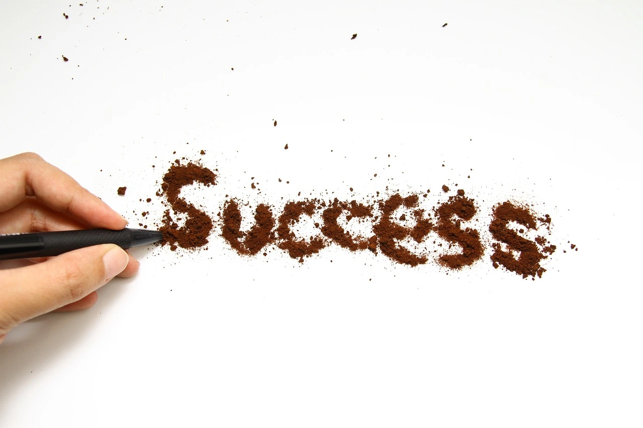Coffee spelling out the word success on table
